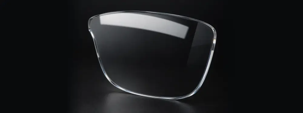 Clear polycarbonate lens with no additional coatings and visible surface reflection